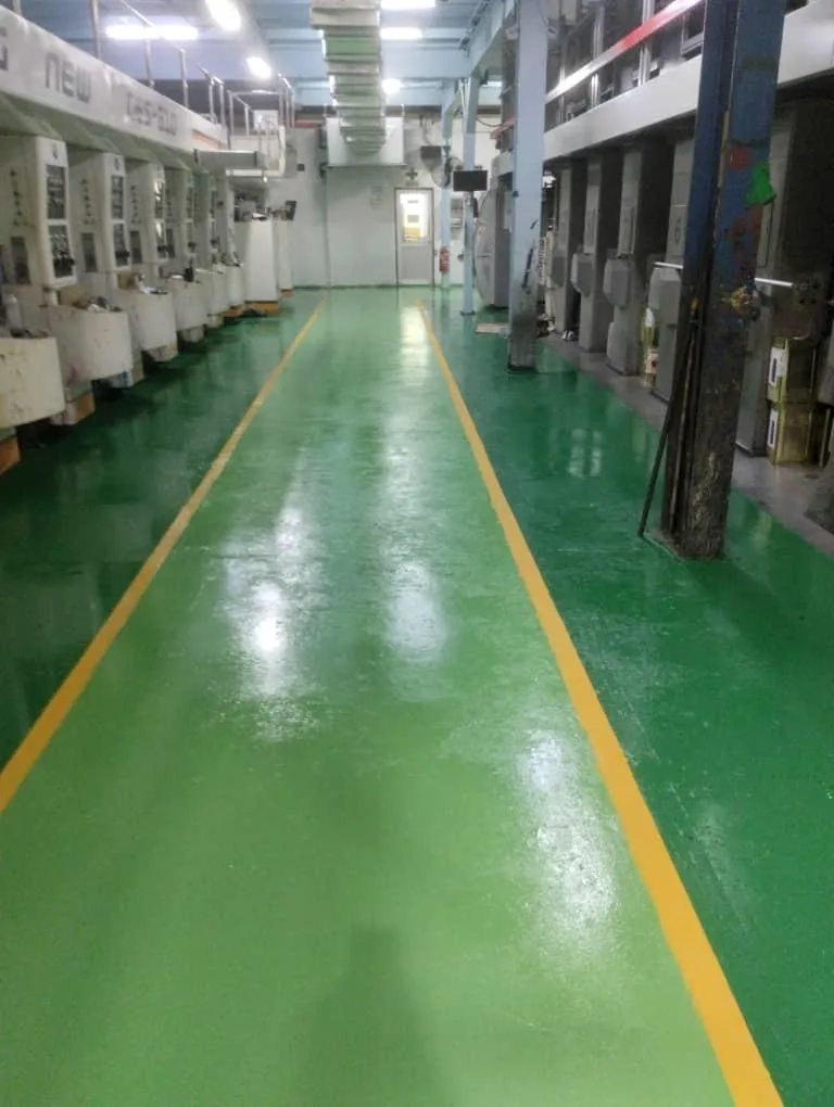 Printing line with a clean, coated green floor and yellow walkway lines